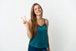© luismolinero - Young caucasian woman over isolated background smiling and showing victory sign