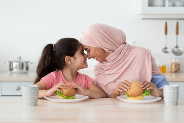 Wall Mural - Lunch With Mommy. Little Girl Eating Sandwiches With Muslim Mother In Kitchen