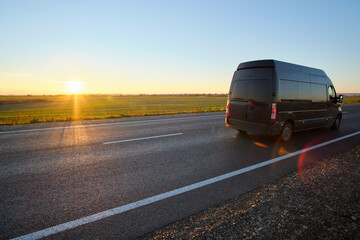 Wall Mural - Small cargo van driving on highway hauling goods. Delivery transportation and logistics concept