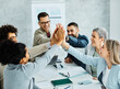 © Lumos sp - businessman businesswoman success young business team high five support unity celebrating give me five  office startup partnership diversity