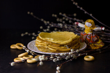 Wall Mural - Background with pancakes, textile dolls, sushki, and pussy-willow for Maslenitsa festival.