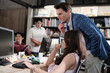 © tigercat_lpg - A young Asian female worker discusses with a caucasian boss in the corporate office, multiracial coworkers, and colleagues about business jobs and creative occupations, the staffs' workplace.