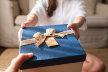 Closeup Image Of A Young Couple Giving And Receiving A Gift Box To Each Other
