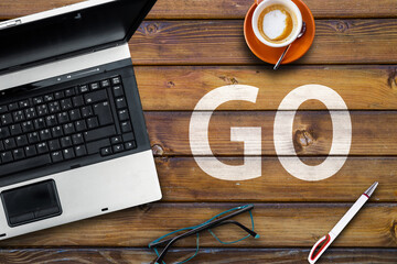 Poster - GO Programming Language. Word go on wooden desk and laptop
