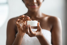 Jar With Body Lotion In Unrecognizable African American Lady Hand