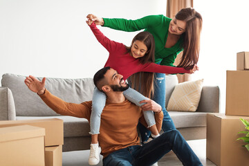 Poster - Portrait of happy Arab family having fun at new home