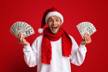 Special Offer. Surprised Man In Santa Hat Holding Fans Of Dollar Cash