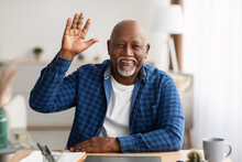 Senior Black Businessman Waving Hand Video Calling Via Laptop Indoor