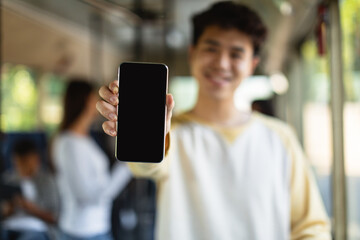 Asian man showing black empty smartphone screen, closeup