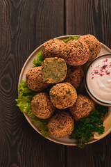 Wall Mural - Chickpea falafel balls, on a wooden table, close-up, vegetarian food,