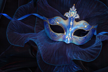 Wall Mural - Photo of elegant and delicate Venetian mask over blue dark background