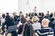 © kasto - Female speaker giving a talk at business meeting. Audience in conference hall. Business and entrepreneurship symposium.