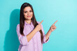 Photo of brunette smart young lady show empty space wear purple cloth isolated on turquoise color background
