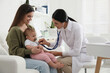 © New Africa - Mother with her cute baby visiting pediatrician in clinic
