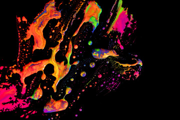 Abstract vibrant multi-color wet paint drops and splotch on black background. Bright orange and pink neon colors. Street art isolated