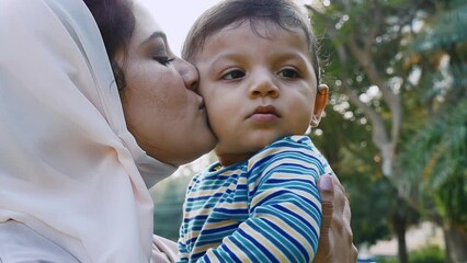 Wall Mural - Mother and little son spending time together at the park. Muslim family outdoor in Dubai. Lifestyle moments in the UAE