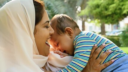 Wall Mural - Mother and little son spending time together at the park. Muslim family outdoor in Dubai. Lifestyle moments in the UAE