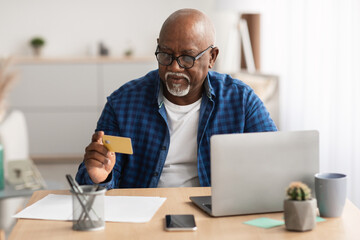 Wall Mural - Senior African American Businessman Shopping Using Card And Laptop Indoor