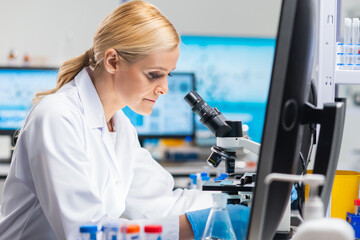 Canvas Print - Professional female scientist is working on a vaccine in a modern scientific research laboratory. Genetic engineer workplace. Future technology and science.