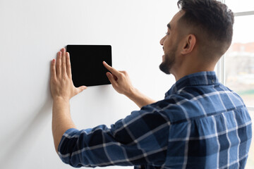 Poster - Happy man using smart wall home control system