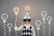 Smart child wearing funny helmet with illuminated lightbulb