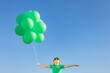 © Igor Yaruta - Happy child with green balloons outdoor