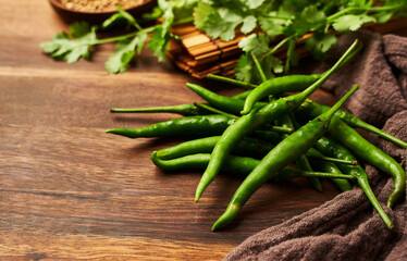 group of green chili pepper on wooden background with copy space      