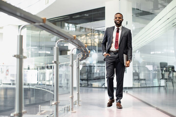 Aufkleber - Positive black manager walking by office building