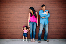 Young Asian-American Family With Toddler Girl And Newborn Baby