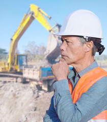 Wall Mural - A middle-aged construction engineer on a construction site, an Asian senior.