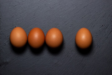 Canvas Print - Chicken eggs on a black surface. Nutritious and delicious breakfast.