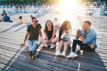 Wall Mural - Group of friends spending time together in park