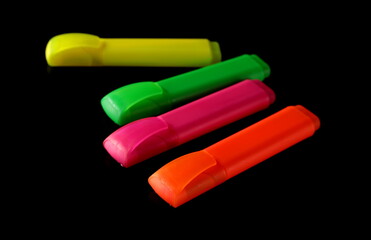 Wall Mural - Colorful fluorescent felt pen markers, highlighters isolated on black 