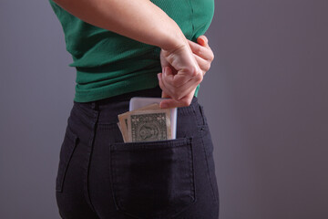 Wall Mural - young girl puts money in her pocket