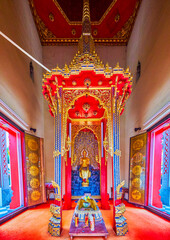 Wall Mural - The interior of the temple of Wat Chakrawat with Altar with golden Buddha, Bangkok, Thailand