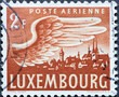 Luxembourg - circa 1946: a postage stamp from Luxembourg, showing a wing of a bird with the cityscape of Luxembourg. airmail