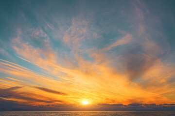 magnificent view of blurry cirrus clouds with gorgeous light and a solar disk over the horizon of th
