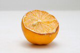 Fototapeta Kuchnia - Sliced wilted lemon on a white background, close-up.