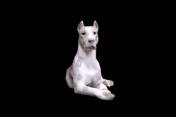 Wall Mural - a dog of the White Great Dane breed is isolated on a black background. porcelain figurine