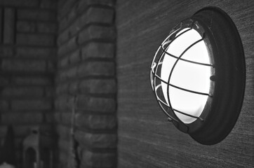 Wall Mural - A grayscale shot of a streetlamp on the wall.