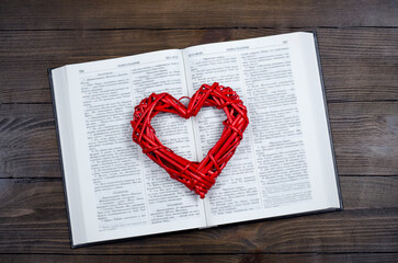 Wall Mural - Open book, Bible. On the table. Red heart. The concept of love for God and Scripture.