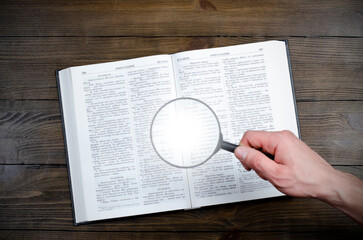 Wall Mural - Open Bible. Magnifier in hand. On the table. Holy Bible, Scripture. Magnifier	