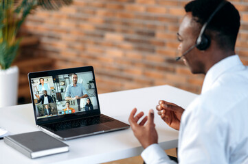 Sticker - Online business meeting of multiracial group. Successful african american man looking at computer screen, talking on video link, talking strategy and workplan, discussing project,plans company future