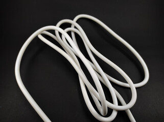 Photo of a white cable isolated on a black background, Not Focus