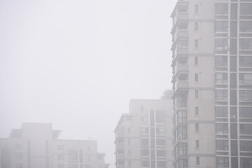 Poster - A beautiful view of buildings in a foggy weather