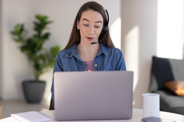 Sticker - Caucasian woman at home remote working on laptop computer talking to her colleague