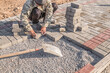 Laying paving slabs by hand on a construction site