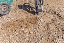 Leveling Gravel With A Hand Shovel