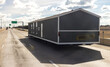 © Moab Republic - Mobile house transportation. Transporting portable home on the highway in Texas. Oversize logistics, semi truck carries a large prefabricated house on semi trailer. Trucking jobs and real estate