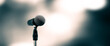 Leinwandbild Motiv Microphone Public speaking background, Close up microphone on stand for speaker speech presentation stage performance with blur and bokeh light background.